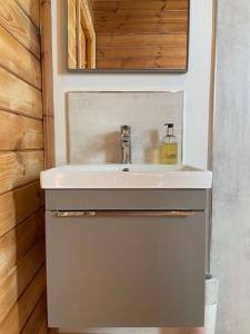 a bathroom with a sink and a mirror at Teal Lodge in Market Rasen