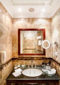 a bathroom with a sink and a mirror at The Dominican in Prague
