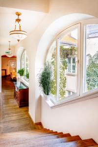 an empty room with a large window and stairs at The Dominican in Prague