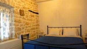 Postel nebo postele na pokoji v ubytování To Portoni Guesthouse
