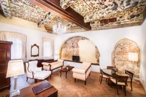 a living room with a couch and chairs and a table at The Dominican in Prague