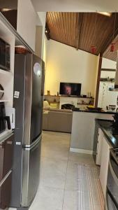 a kitchen with a stainless steel refrigerator in a room at Casa com piscina zona sul Rio perto Estação Corcovado in Rio de Janeiro