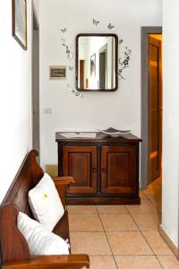 a mirror on a wall with a couch in a room at Cà MEA in Re