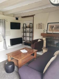 a living room with a couch and a table at Gîte L'Escale Charmante in Choussy