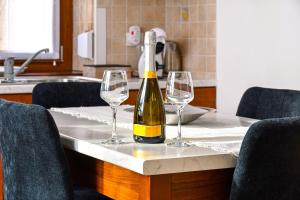 a bottle of wine sitting on a table with two wine glasses at Cà MEA in Re +28 photos