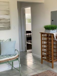 a living room with a chair and a table at Elegant Brand New Apartment in Central Burlington in Burlington