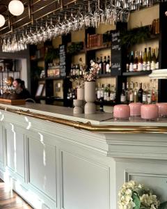 a bar with a counter with bottles of alcohol at Hotell Gillet i Köping in Köping