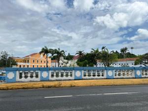 a blue and white wall on the side of a road at Pousada do Leo in Olinda