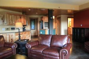 a living room with leather couches and a kitchen at #722 Trout Hill Condo at Fall Creek Falls in Sampson