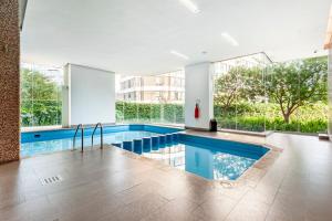 a swimming pool in a building with a large window at Luxury apart with amazing pool, gym, sauna, wifi in Mexico City