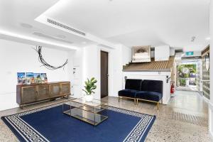 a living room with a couch and a table at Nest on Newcastle - S4 in Perth
