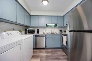 a kitchen with blue cabinets and white appliances at Peaceful APT by Lakebottom w Arcade 8mi Ft Moore in Columbus