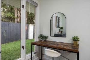 a bathroom with a table and a mirror and a window at Peaceful APT by Lakebottom w Arcade 8mi Ft Moore in Columbus