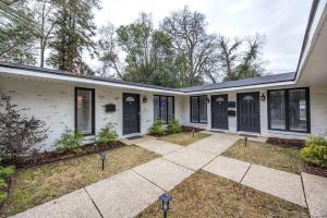 an exterior view of a white house with black shutters at Peaceful APT by Lakebottom w Arcade 8mi Ft Moore in Columbus