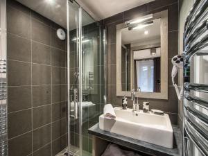 a bathroom with a sink and a glass shower at Salers : Elegant 3 pièces rénové avec grand salon et salle à manger, centre Moriond, 4/6 personnes - FR-1-563-8 in Courchevel