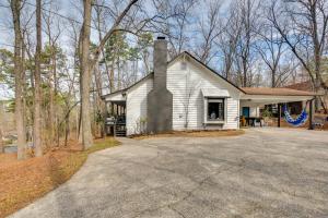 a white house with a chimney and a driveway at 3 Mi to Marietta Square Hot Tub Haven with 2 Patios in Marietta