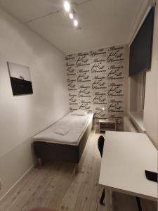a room with a bed and a wall with writing on it at Vandrarhem 11 RUM & KÖK in Sandviken +28 photos