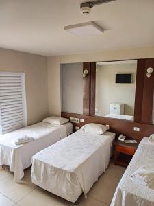 Katil atau katil-katil dalam bilik di Piloes Palace Hotel