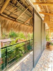 an internal view of a patio with a large glass window at Private Room with Starlink and AC Steps from the Sea in Brisas de Zicatela +6 photos