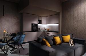 a living room with a couch and a kitchen at CM Luxury Apartment in Catania