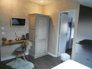 a bedroom with a bed and a desk and a chair at Cit'Hotel Avantici Gap in Gap