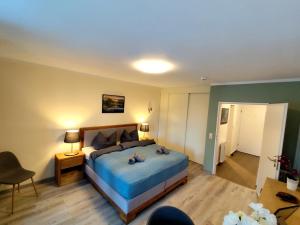 a bedroom with a bed with two stuffed animals on it at Apartment Harzgeflüster in Bad Harzburg