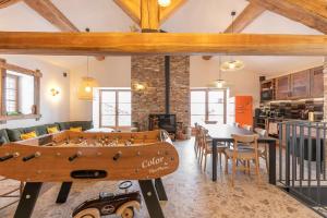 a living room with a wooden foosball table at Les Greppes in Bonneval-sur-Arc
