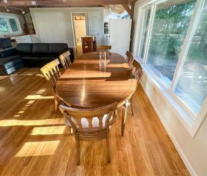 a wooden table and chairs in a living room at Sq Gretas Place in Sequim