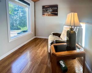 a living room with a couch and a table with a lamp at Sq Gretas Place in Sequim