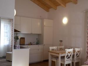 a kitchen with a table and chairs in a room at Ferienwohnung Vitalis in Bad Bayersoien