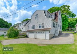 a large white house with a garage at Velocity Residence in Worcester