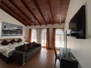 a bedroom with a large bed and a couch at Air Suites Hotel Boutique in Quito