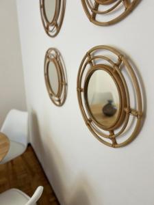 a wall with a mirror on a white wall at Otto's Home Horizonte in Lastres +19 photos