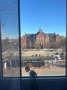 a view of a large building from a window at Pension Brema Apartment 1 Zimmer in Bremerhaven