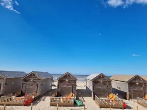 a row of beach huts on the beach at Strandvakantiehuisjes Katwijk in Katwijk aan Zee