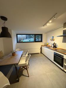 a kitchen with a table and chairs and a table and a counter at Miltenberg Moments Ferienwohnung in Miltenberg