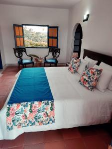 Postel nebo postele na pokoji v ubytování Ecohotel Guaduales Nature + 37 fotografií