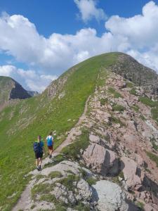 two people walking up a hill on a trail at Apartment with terrace - Monte Ponente in Tassullo