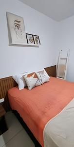 En eller flere senge i et værelse på Aconchego Próximo ao Mar