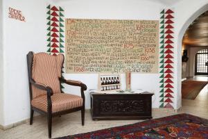 a chair and a table in a room with a wall at Brauereigasthof-Hotel Roter Ochsen in Ellwangen +5 photos