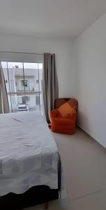 En eller flere senge i et værelse på Aconchego Barulho do Mar