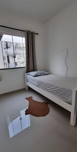 En eller flere senge i et værelse på Aconchego Barulho do Mar