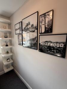 a room with four pictures on a wall at 2 Bed Apartment in Greenwich, Free Parking, DLR in London