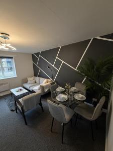 a living room with a table and a couch at 2 Bed Apartment in Greenwich, Free Parking, DLR in London