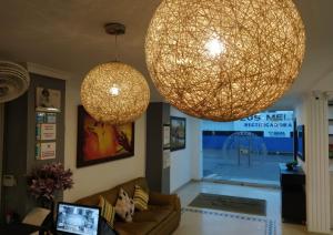 a living room with two large lights hanging from the ceiling at Hotel La Casa 1 in Montería