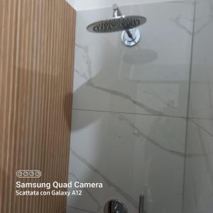 a shower with a shower head in a bathroom at Jenny's house in Castellammare di Stabia