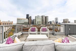 a balcony with couches and a view of the city at Cityscape Condotel on First Hill-Capitol Hill in Seattle