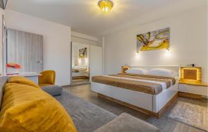 a bedroom with a bed and a living room at 2 Bedroom Stunning Home In Skatari in Šikići