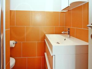 a bathroom with a sink and a toilet at Appartementhaus, Zinnowitz in Zinnowitz +19 photos