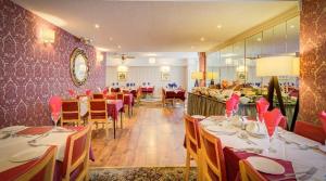 a dining room with tables and chairs in a restaurant at Adelaide House Hotel - Opposite Winter Gardens, Town Centre in Blackpool